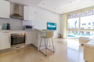 a kitchen with a counter and a chair in a room at Mangroovy Seaview 1BR Beach and Pool Free access in Hurghada