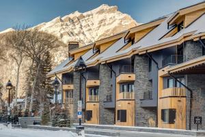 a row of apartment buildings with snow covered roofs at Peaks Hotel and Suites in Banff
