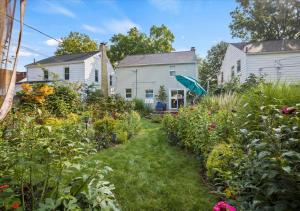 a garden with flowers and plants in front of a house at Charming 3 Bedroom House in a Quiet Neighborhood in Columbus