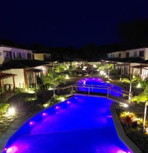 a swimming pool at night with purple lights at Casa em Barra Grande com piscina in Marau