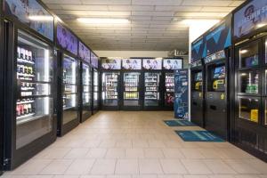 a store aisle with vending machines and soda machines at Premium City Apartment with balcony! Free Garage Parking included! in Vienna