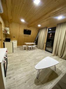 a room with a table and chairs and a tv at Green Villa Resort White in Dilijan