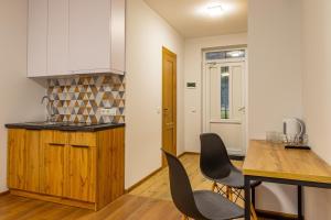 a kitchen and dining room with a table and chairs at GARDA - Breakfast included in the price Restaurant Free Parking Mountain view Kitchen in the apartment separate entrance in Bukovel