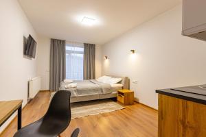 a bedroom with a bed and a desk with a chair at GARDA - Breakfast included in the price Restaurant Free Parking Mountain view Kitchen in the apartment separate entrance in Bukovel
