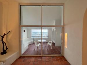 a room with sliding glass doors leading to a dining room at OceanBlue Resort in Christ Church
