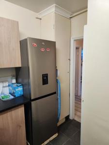 a kitchen with a stainless steel refrigerator in a room at 2-bedroom flat in Cutty-Sark, Greenwich ! in London