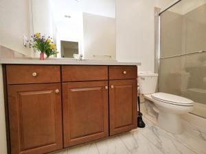 a bathroom with a sink and a toilet and a shower at Luxury 3 Bedroom House Near Sacramento Airport in Sacramento
