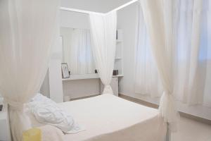 Postel nebo postele na pokoji v ubytování Hostal Mamà Mambò - Zona Colonial