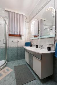 a bathroom with two sinks and a shower at Apartment Dante Alighieri in Opatija