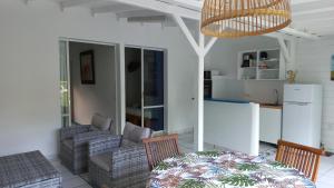 a living room with a couch and a table at Village Le Pre in Terre-de-Haut