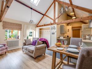 a living room with a table and a couch at The Parlour - Uk10958 in Burlton