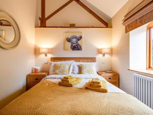 a bedroom with a bed with towels on it at The Parlour - Uk10958 in Burlton