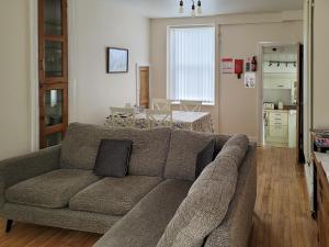 a living room with a couch and a kitchen at Frannys Cottage in Penmaen-mawr