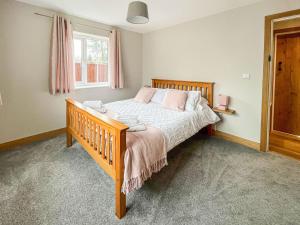 a bedroom with a bed and a window at The Willows - Uk34000 in Child Okeford