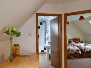 a attic room with a bed and a mirror at Kimberley Apartment in Alness