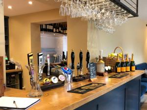 a bar with bottles of wine on a counter at The Old Kitchen -uk32062 in Burwarton