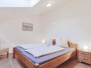 a bedroom with a wooden bed with a blue mattress at Igl Hof Top 4 in Westendorf