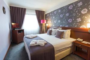 a hotel room with a bed with towels on it at Dila Hotel in Istanbul