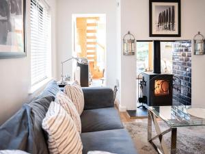 a living room with a couch and a fireplace at Peakaboo in Sidmouth