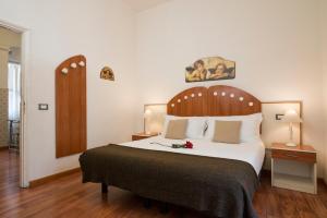 ローマにあるNavona Tower Apartmentsのベッドルーム1室(大型ベッド1台、木製ヘッドボード付)