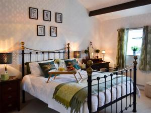 a bedroom with a bed with a table on it at The Lodge in Dyserth