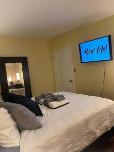 a bedroom with a bed with a sign on the wall at Enhanced 2Bedroom in Williams Bridge