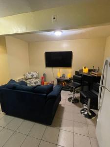 a living room with a couch and a flat screen tv at Enhanced 2Bedroom in Williams Bridge