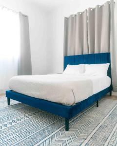 a bed with a blue frame in a bedroom at Coconut Breeze 2 in Saint Philip