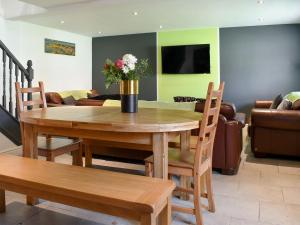 a dining room table with a vase of flowers on it at St Hildas Rest in Hinderwell