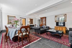 a living room with a table and a couch at The Coach House in Blaenporth