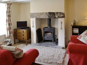 a living room with a fireplace and a stove at Beckside in Bellerby