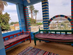 two benches on a porch with a view of the beach at ارجوندي جيست هاوس in Aswan