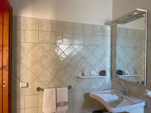 a bathroom with a sink and a mirror at Mura Guest Room in Terralba +43 photos