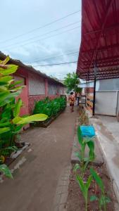 a person walking down a sidewalk next to a building at Dua Nina 2 Guesthouse in Gili Trawangan