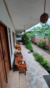 a row of tables and chairs on a patio at Dua Nina 2 Guesthouse in Gili Trawangan