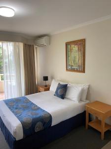 a hotel room with a large bed and a window at Wahroonga Furnished Apartments in Hornsby