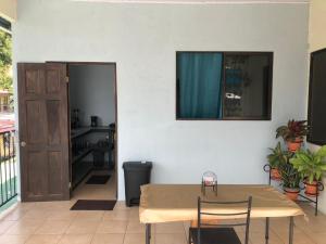 a room with a table and chairs and a door at Los Sueños IyE 4 in Quepos