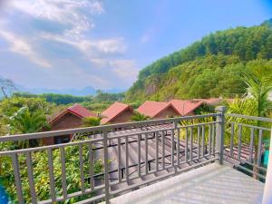 a balcony with a view of a mountain at The Hill Villas in Phong Nha