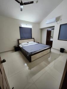 a bedroom with a bed in the middle of it at VedGanga Plus Villa - Homestay in Kolhapur