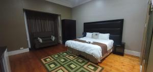 a bedroom with a large bed in a room at Brando bnb in King Williamʼs Town