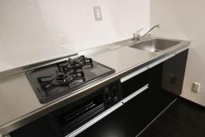 a stove top oven in a kitchen next to a sink at Yadoya Matsumoto Honjo - Vacation STAY 13372v in Matsumoto