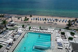 an overhead view of a swimming pool and a beach at OneLuxStay at W Residences in Fort Lauderdale