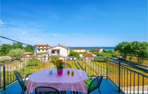 a table with a doll sitting on top of a balcony at Beautiful Home In Peruski With Kitchen in Peruški