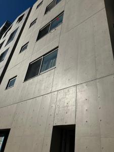 a concrete building with windows on the side of it at PRISM Inn Komagata Asakusa in Tokyo