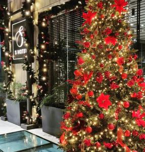 a christmas tree in front of a store at S Hotel Boutique Thessaloniki in Thessaloniki