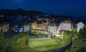 コパオニクにあるApartman Dream,Kraljevi Čardaci, sa garažnim mestomのテニスコートが目の前にある大きな建物