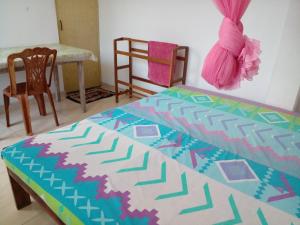 una camera da letto con un letto, un tavolo e una sedia di Jayanthi Surf Dreams a Midigama East
