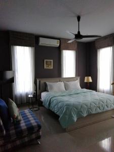 a bedroom with a bed and a ceiling fan at Klong Muang Beach Apartment in Klong Muang Beach