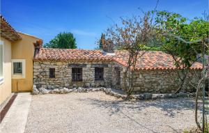 a stone house with a red roof at Maison Des Rêves in Saint-Cézaire-sur-Siagne