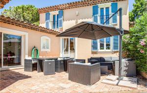 a patio with a table and an umbrella at Maison Des Rêves in Saint-Cézaire-sur-Siagne +35 photos